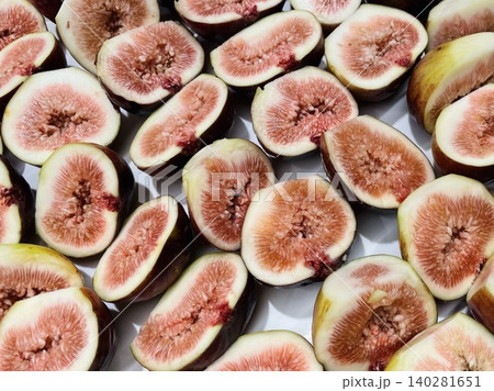 Freshly sliced fig revealing its juicy, ruby-red interior with tiny edible seeds. Sweet, delicious, and perfect for desserts, salads, and healthy snacks. A nutritious and exotic fruit! Freshly sliced fig revealing its juicy, ruby-red interior with tiny edible seeds. Sweet, delicious, and perfect for desserts, salads, and healthy snacks. A nutritious and exotic fruit! 140281651