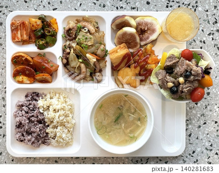 A vibrant spread of Korean food on the table, featuring various banchan (side dishes) like kimchi, pickled vegetables, and seasoned greens. Perfect for food photography, showcasing traditional Korean. 140281683
