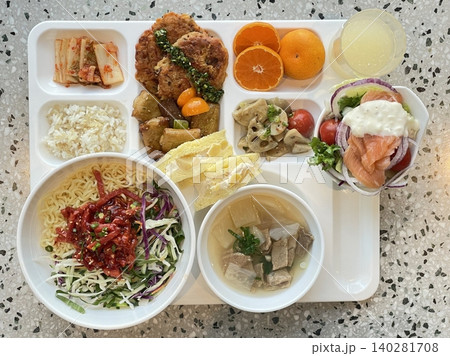 A vibrant spread of Korean food on the table, featuring various banchan (side dishes) like kimchi, pickled vegetables, and seasoned greens. Perfect for food photography, showcasing traditional Korean. 140281708