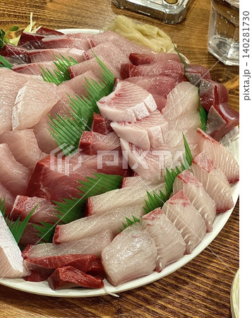 Fresh and delicate sashimi slices, beautifully presented with vibrant colors and perfect cuts. This traditional Japanese delicacy highlights the pure flavors of premium seafood. Fresh and delicate sashimi slices, beautifully presented with vibrant colors and perfect cuts. This traditional Japanese delicacy highlights the pure flavors of premium seafood. 140281730