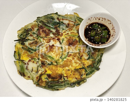 Pajeon is a savory Korean pancake made with green onions (pa) in a light batter, often mixed with seafood like squid or shrimp. Crispy on the outside and soft inside, it’s a flavorful side dish. Pajeon is a savory Korean pancake made with green onions (pa) in a light batter, often mixed with seafood like squid or shrimp. Crispy on the outside and soft inside, it’s a flavorful side dish. 140281825