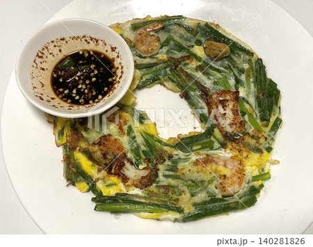 Pajeon is a savory Korean pancake made with green onions (pa) in a light batter, often mixed with seafood like squid or shrimp. Crispy on the outside and soft inside, it’s a flavorful side dish. Pajeon is a savory Korean pancake made with green onions (pa) in a light batter, often mixed with seafood like squid or shrimp. Crispy on the outside and soft inside, it’s a flavorful side dish. 140281826