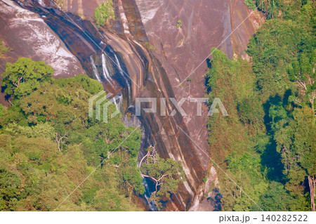 Rocky mountain waterfall surrounded by dense tropical rainforest near Langkawi Sky Bridge Malaysia Rocky mountain waterfall surrounded by dense tropical rainforest near Langkawi Sky Bridge Malaysia 140282522