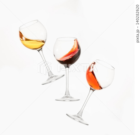 Wine of different colors, varieties splashes in stemware. 140282620