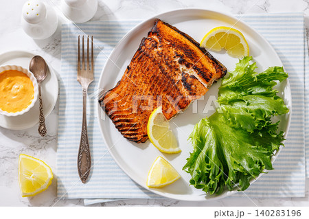 Baked salmon fish fillet with salad and lemon Baked salmon fish fillet with salad and lemon 140283196