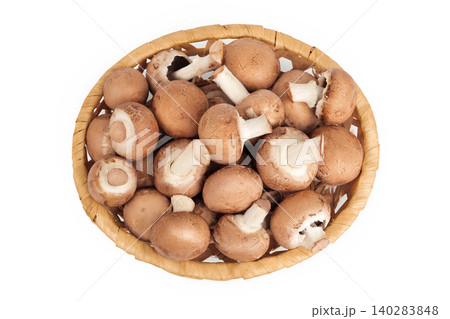 Brown champignon mushroom a wicker basket isolated on white background. Top view. Flat lay Brown champignon mushroom a wicker basket isolated on white background. Top view. Flat lay 140283848