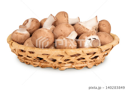 Brown champignon mushroom in a wicker basket isolated on white background 140283849