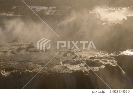 Majestic iguazu falls cascade over rugged rock creating an awe inspiring heavy mist Majestic iguazu falls cascade over rugged rock creating an awe inspiring heavy mist 140284099