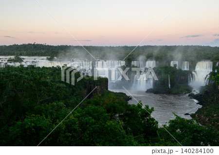 Majestic iguazu falls landscape surrounded by green forest at peaceful sunset Majestic iguazu falls landscape surrounded by green forest at peaceful sunset 140284100
