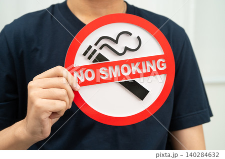 Male holding a no smoking sign. Male holding a no smoking sign. 140284632