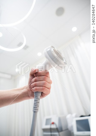 Medical professional preparing treatment equipment in clinic environment Medical professional preparing treatment equipment in clinic environment 140284647