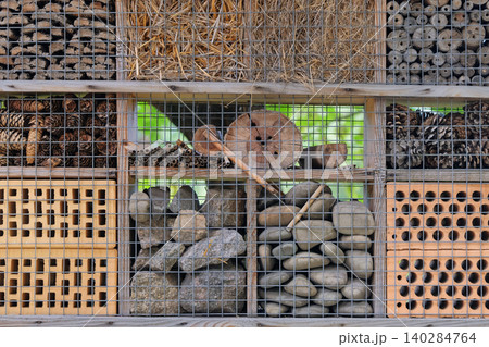 Insect house in summer garden. Bug hotel. Shelter for insect in outdoor. Insect ecosystem. Insect house in summer garden. Bug hotel. Shelter for insect in outdoor. Insect ecosystem. 140284764