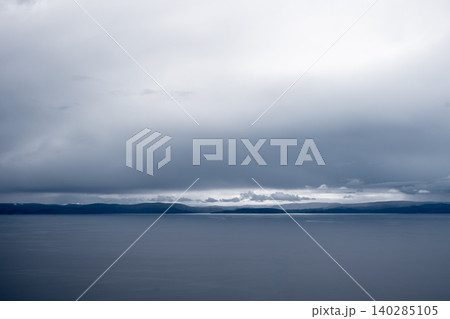 View of Lake Titicaca from Amantani Island under stormy clouds 140285105