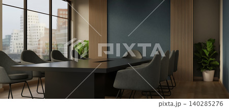 Black table and curved chairs beside blue wall and window with city view in meeting room at company. 140285276