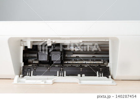 Close-Up Interior View Of A Home Printer With Open Tray Showing Ink Cartridges And Feed Mechanism Close-Up Interior View Of A Home Printer With Open Tray Showing Ink Cartridges And Feed Mechanism 140287454