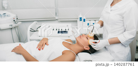 Beautiful woman receiving facial beauty procedure for lifting skin. 140287761
