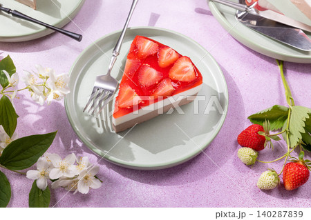 Strawberry cheesecake slice with jelly topping and fresh berries 140287839