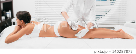 woman having cavitation procedure on legs and buttocks , cellulite treatment at beauty clinic woman having cavitation procedure on legs and buttocks , cellulite treatment at beauty clinic 140287875