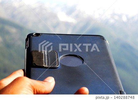 Tablet Case Held Outdoors with Mountain Background Tablet Case Held Outdoors with Mountain Background 140288748