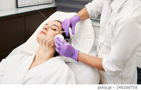 Beauty injections into a beautiful woman face, smoothing of mimic wrinkles around the eyes using biorevitalization Beauty injections into a beautiful woman face, smoothing of mimic wrinkles around the eyes using biorevitalization 140288758