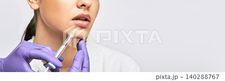 Lip augmentation. Cropped sensual female lips while procedure lip augmentation using injections with dermal filler for increase lip fullness 140288767