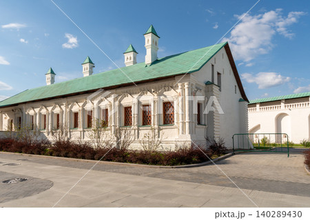 Historic White Stone Building With Green Roof And Ornate Windows Under Blue Sky Historic White Stone Building With Green Roof And Ornate Windows Under Blue Sky 140289430