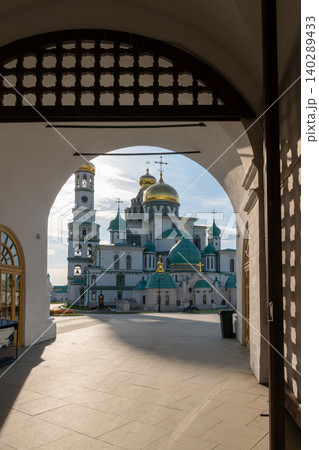 View Through Archway of Russian Orthodox Monastery With Gold and Green Domes at Sunrise 140289433