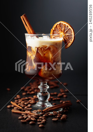 Iced coffee with cream on a black background. Iced coffee with cream on a black background. 140289556