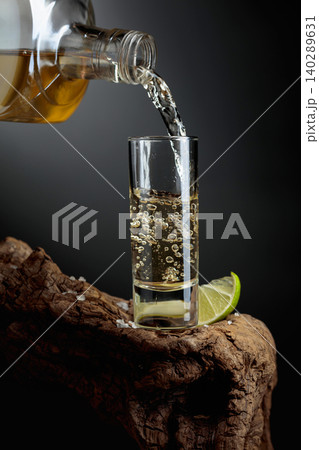Gold tequila with salt and lime. 140289631