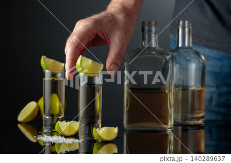 Gold tequila with sea salt and lime slices. Gold tequila with sea salt and lime slices. 140289637