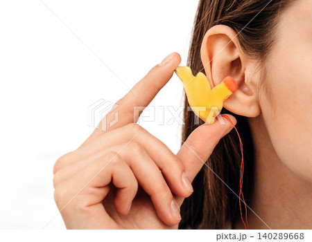 Process of making earplugs from an impression of an individual human ear. Ear close-up. Personally molded earplugs. Part of the set 140289668