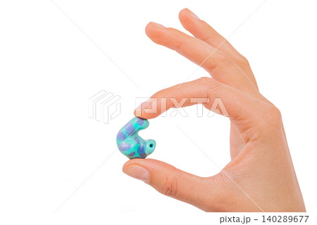 isolated on white earplug in hand. personally molded earplugs close-up 140289677
