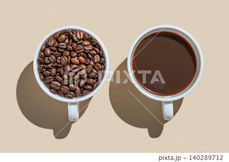 Freshly brewed espresso in a white cup and coffee beans on a yellow isolated background Freshly brewed espresso in a white cup and coffee beans on a yellow isolated background 140289712