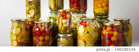 Canning is a common activity in the kitchen as jars filled with vegetables and fruits line the counter. This practice helps in preserving food for winter use and has a long tradition, banner Canning is a common activity in the kitchen as jars filled with vegetables and fruits line the counter. This practice helps in preserving food for winter use and has a long tradition, banner 140290134