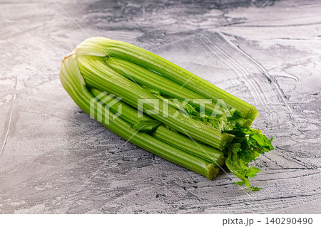 Fresh green celery stalks on grey textured background Fresh green celery stalks on grey textured background 140290490