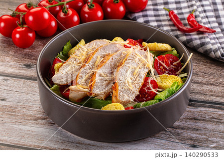 Grilled chicken caesar salad with cherry tomatoes and croutons in bowl Grilled chicken caesar salad with cherry tomatoes and croutons in bowl 140290533