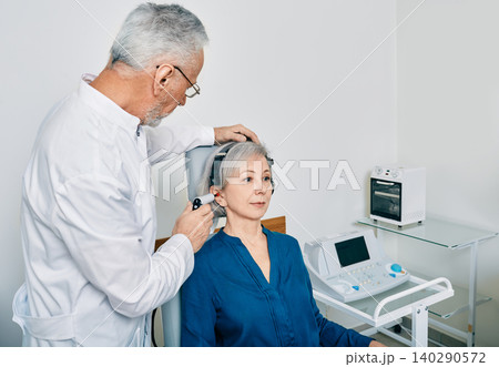Mature audiologist with tympanometer probe doing procedure tympanometry or impedance audiometry for senior woman patient at hearing clinic Mature audiologist with tympanometer probe doing procedure tympanometry or impedance audiometry for senior woman patient at hearing clinic 140290572