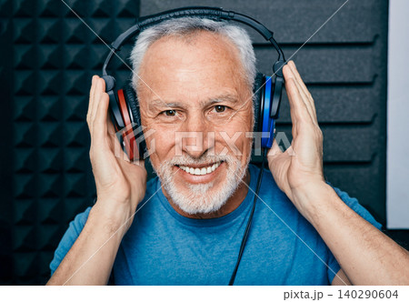 Hearing loss treatment. Positive senior man wearing audiometry headphones while hearing test and audiogram in special audio room Hearing loss treatment. Positive senior man wearing audiometry headphones while hearing test and audiogram in special audio room 140290604