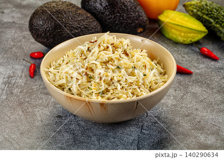 Bowl of Jeera Rice with Avocados and Starfruit on Gray Background Bowl of Jeera Rice with Avocados and Starfruit on Gray Background 140290634
