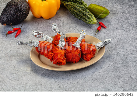 Chicken lollipop dish with vegetables on stone table Chicken lollipop dish with vegetables on stone table 140290642