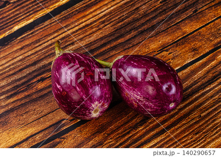 two fresh purple eggplants on rustic wooden table background two fresh purple eggplants on rustic wooden table background 140290657