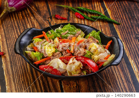 Tuna salad with fresh vegetables and peppers on wooden table Tuna salad with fresh vegetables and peppers on wooden table 140290663