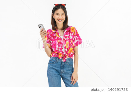 Portrait of young Asian woman in summer wearing floral shirt holding smartphone and smiling on white background. 140291728