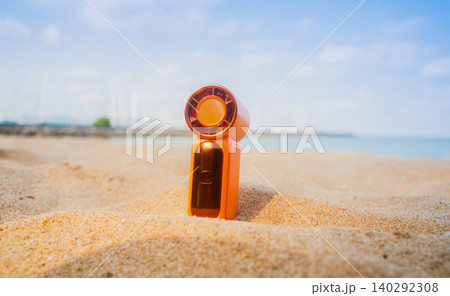 Portable handy fan on the beach and the background is the sea and the sky in summer. 140292308
