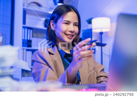 Young Asian businesswoman working on laptop in office, professional corporate employee and digital business concept. 140292798