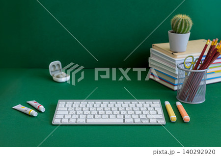 Colorful school supplies on a green background 140292920