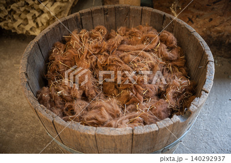 Raw Wool Collected in a Barrel on a Farm 140292937