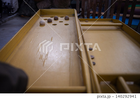 Vintage wooden sjoelbak game set up on farm Vintage wooden sjoelbak game set up on farm 140292941