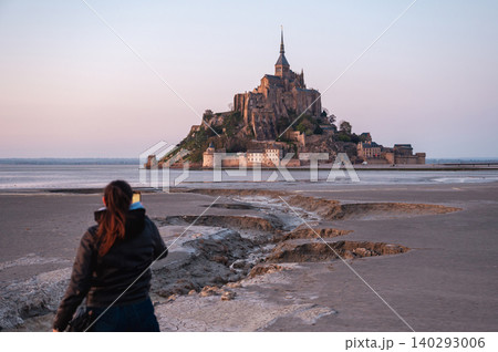 Girl Standing in Front of Mont-Saint-Michel, France Girl Standing in Front of Mont-Saint-Michel, France 140293006
