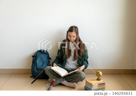 Teenage student holding books on white background Teenage student holding books on white background 140293031